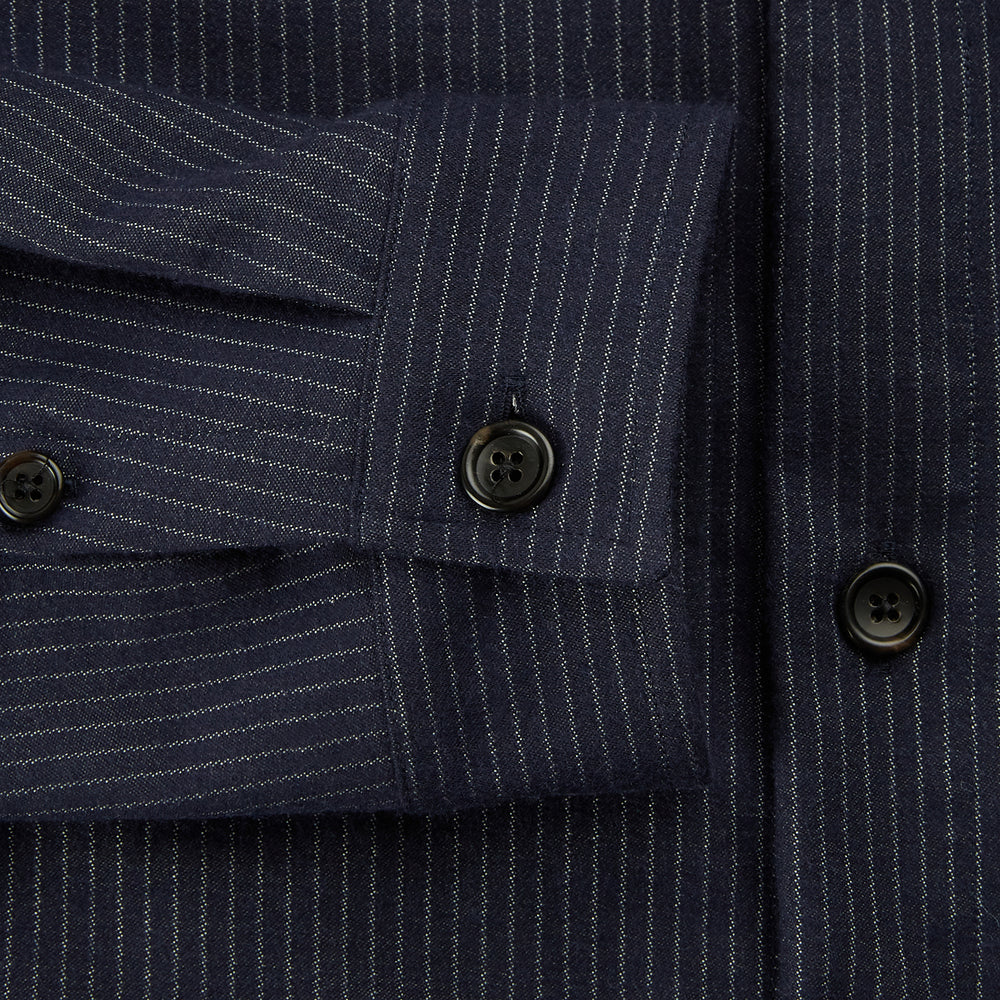 The Turnbull & Asser Navy Stripe Hampstead Overshirt features pinstripes, a collar, long sleeves, chest pocket, and two angled side pockets—ideal for refining your formal look. Shown laid flat on a light background.
