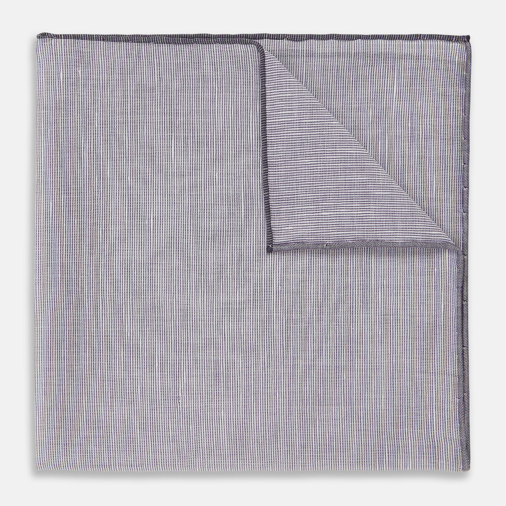 The Lilac Cotton-Blend Handkerchief by Turnbull & Asser is neatly folded with a corner flipped over, exposing the hand-rolled edges, and displayed against a white background.