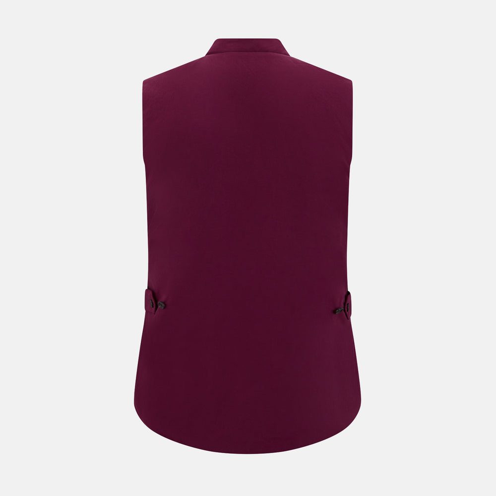The Turnbull & Asser Wine Red Padded Gilet features a sleeveless design, front zipper, two zippered side pockets, a slanted chest pocket, and a rounded hem—perfect for the modern gentleman and shown on a plain white background.