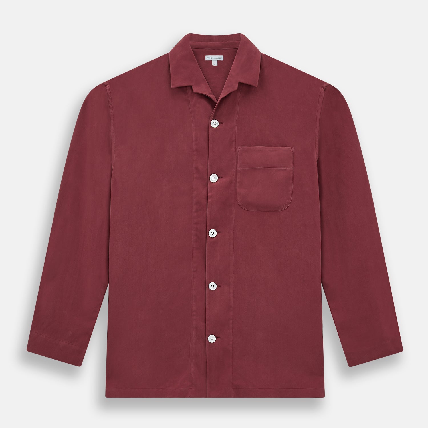 View 4 of product The Turnbull & Asser Burgundy Silk Pyjama Set features a long-sleeve, button-up shirt with chest pocket and matching pants with elastic waistband and side pocket, shown on a white background.