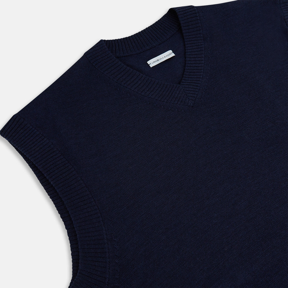 The Turnbull & Asser Navy Fine Merino V-Neck Vest is a sleeveless sweater exuding sophistication with its classic design, shown on a plain white background.
