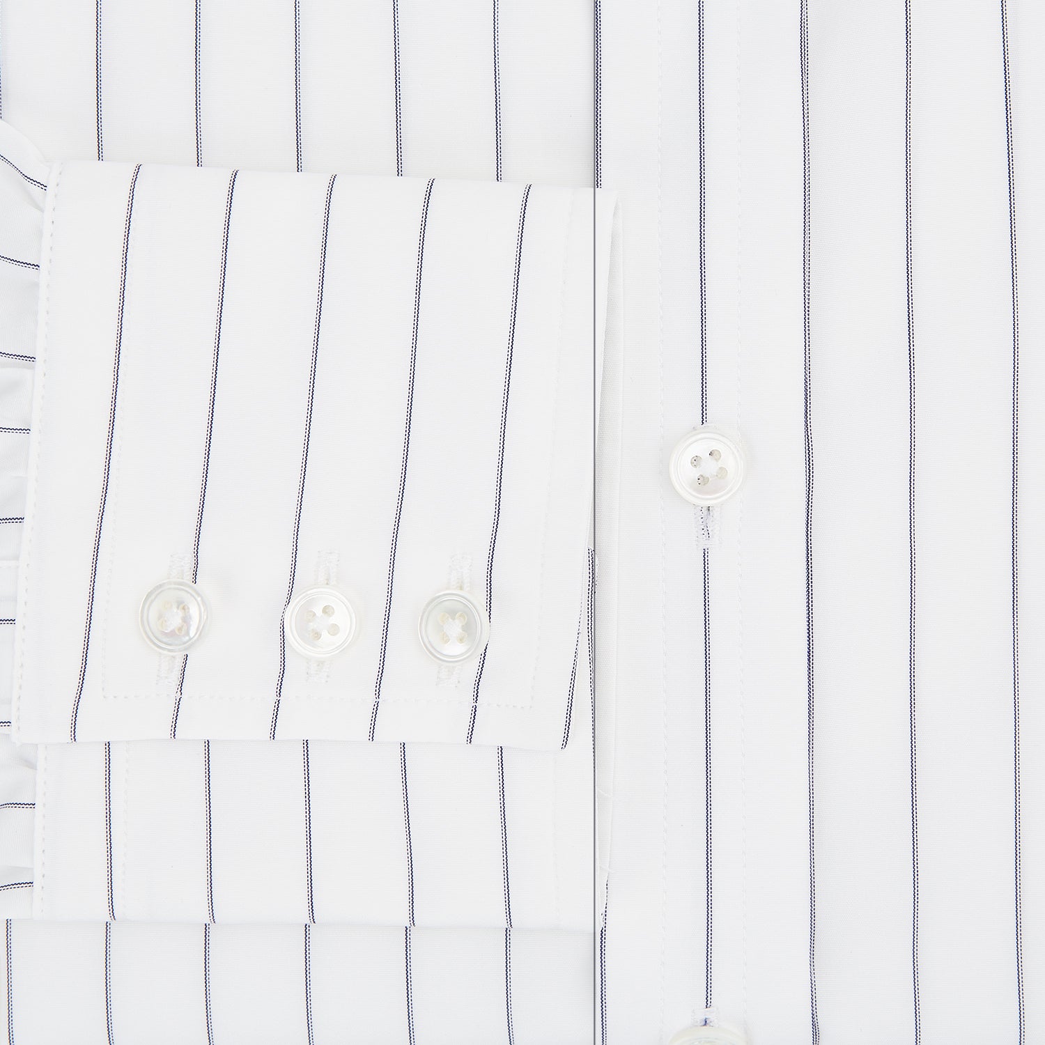 View 4 of product The Turnbull & Asser Navy Hairline Multi Stripe Mayfair Shirt, made from fine Italian cotton with navy stripes, a pointed collar, and buttoned cuffs, is shown laid flat on a plain white background.