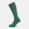 View 1 of product The Turnbull & Asser Forest Green/Navy Dot Mid-Length Sock is shown upright with the foot pointed right against a white background, highlighting its subtle polka dot pattern.