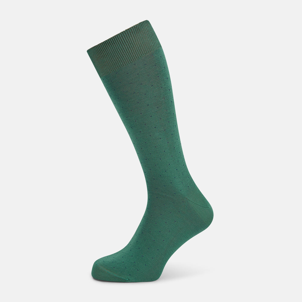 The Turnbull & Asser Forest Green/Navy Dot Mid-Length Sock is shown upright with the foot pointed right against a white background, highlighting its subtle polka dot pattern.