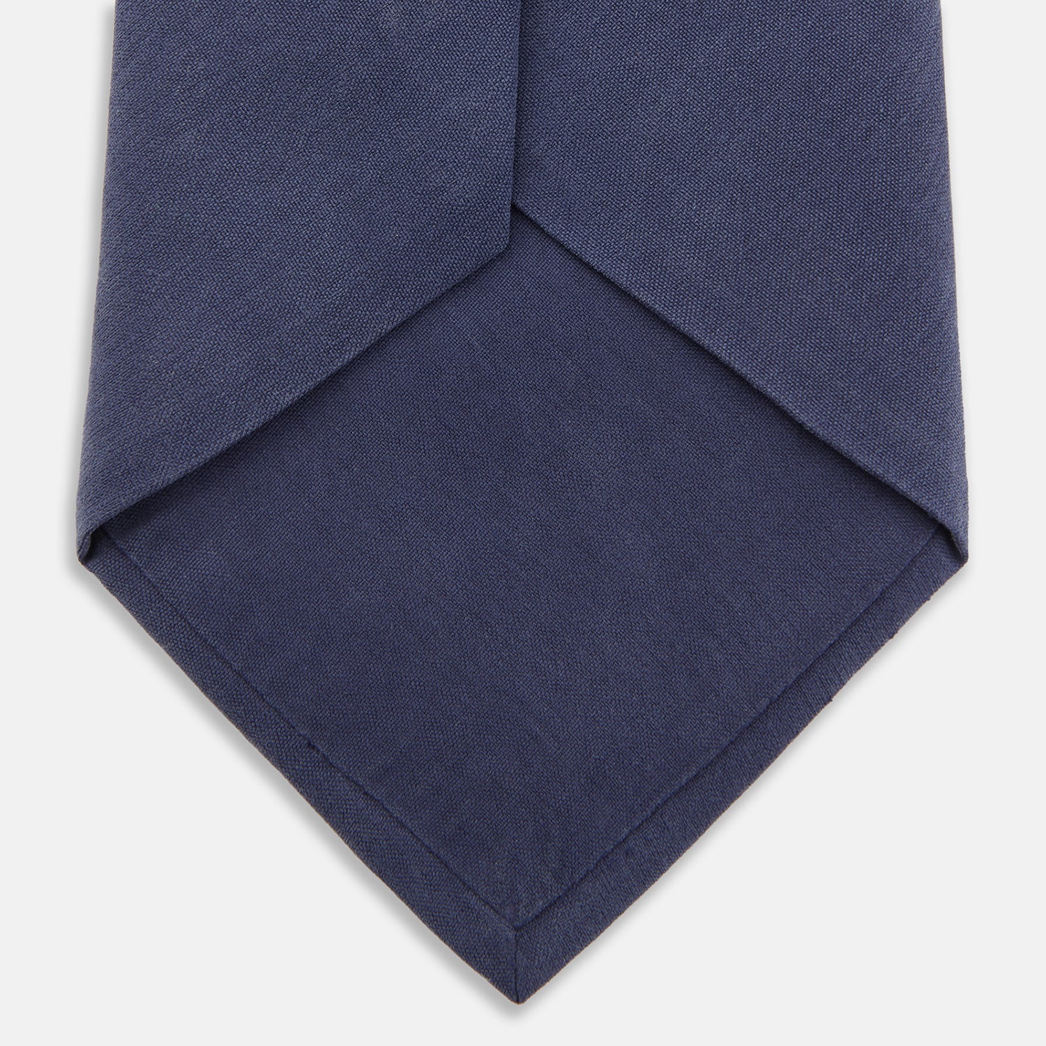 View 2 of product The Turnbull & Asser Navy Gold Embroidered Botanical Tie features intricate gold botanical embroidery on navy blue silk, neatly rolled with the detailed tip facing forward.