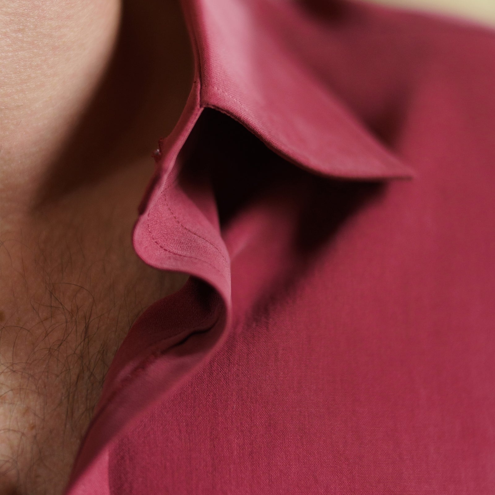 View 4 of product The Turnbull & Asser Burgundy Silk Shirt features a T&A collar and 3-button cuffs, offering a refined alternative to a black tie for modern style. Displayed folded on a white background.
