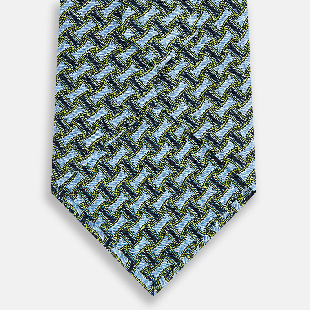 The Turnbull & Asser Light Blue and Chartreuse Lemon Weave Patterned Silk Tie, crafted from fine English silk, features a geometric design in blue and green tones, displayed on a plain white background.