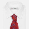 View 2 of product The Turnbull & Asser MINI SQUARE SPOT TULIP RED BLUE TIE features a vivid red base with blue and white geometric spots, making it a stylish addition to any refined ensemble.