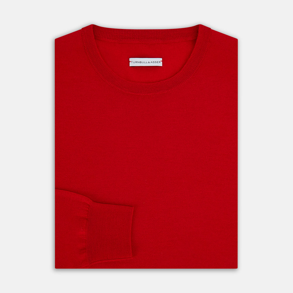 The Turnbull & Asser Red Merino Round Neck Jumper features long sleeves, ribbed cuffs and hem—a classic men's knitwear essential shown on a white background.
