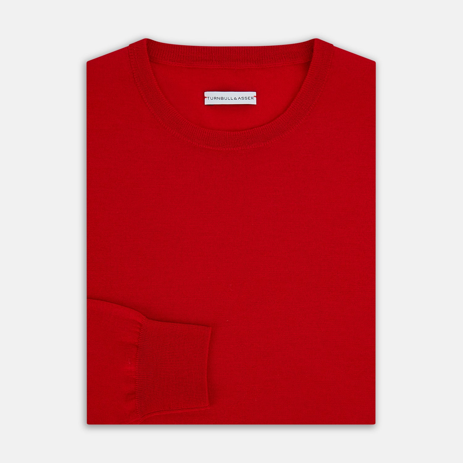 View 4 of product The Turnbull & Asser Red Merino Round Neck Jumper features long sleeves, ribbed cuffs and hem—a classic men's knitwear essential shown on a white background.
