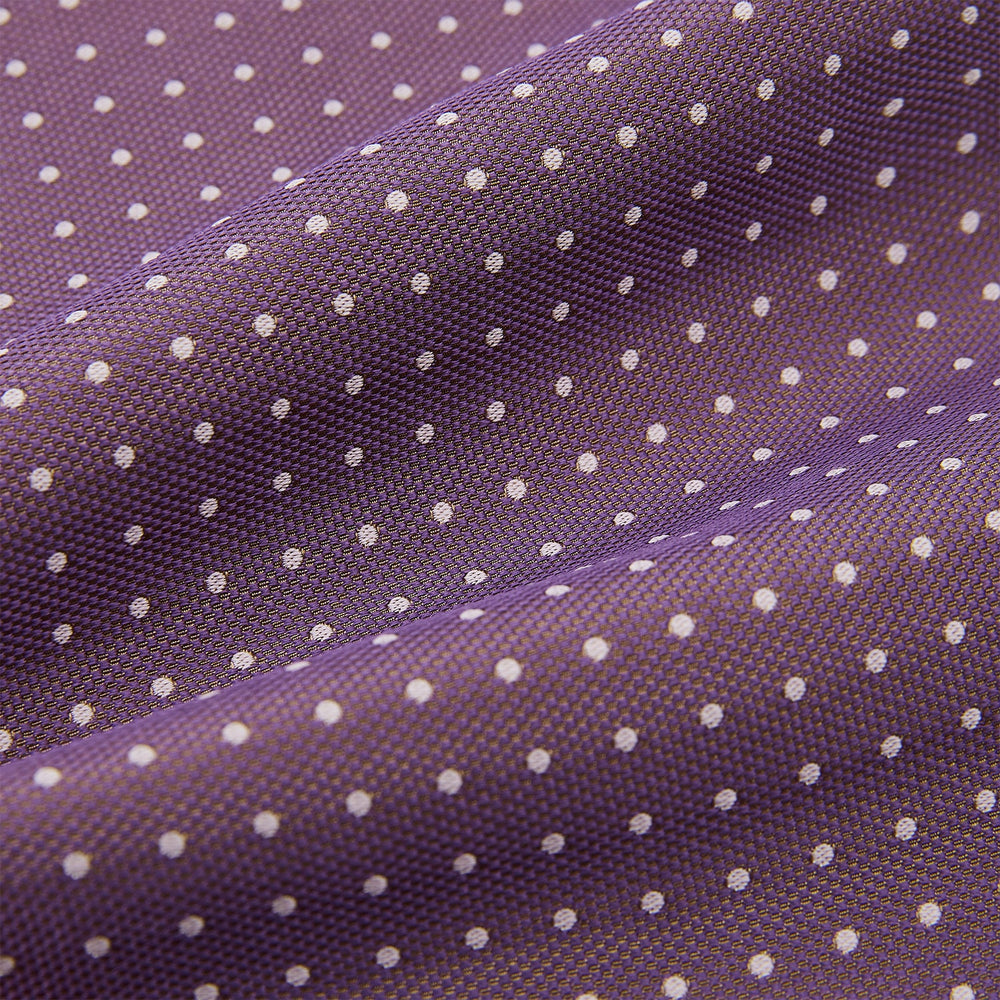 The Lilac and Violet Micro Dot Silk Cravat by Turnbull & Asser features small white polka dots on elegant silk, expertly crafted for a refined look, and is shown against a white background.