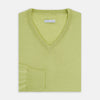 View 4 of product The Turnbull & Asser Melon Green Merino V-Neck Jumper is shown on a white background, featuring long sleeves, ribbed cuffs, and a ribbed hem.