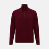 View 1 of product The Turnbull & Asser Ruby Red Half-Zip Cashmere Jumper, with a stand-up collar and elegant design, is displayed against a plain white background.