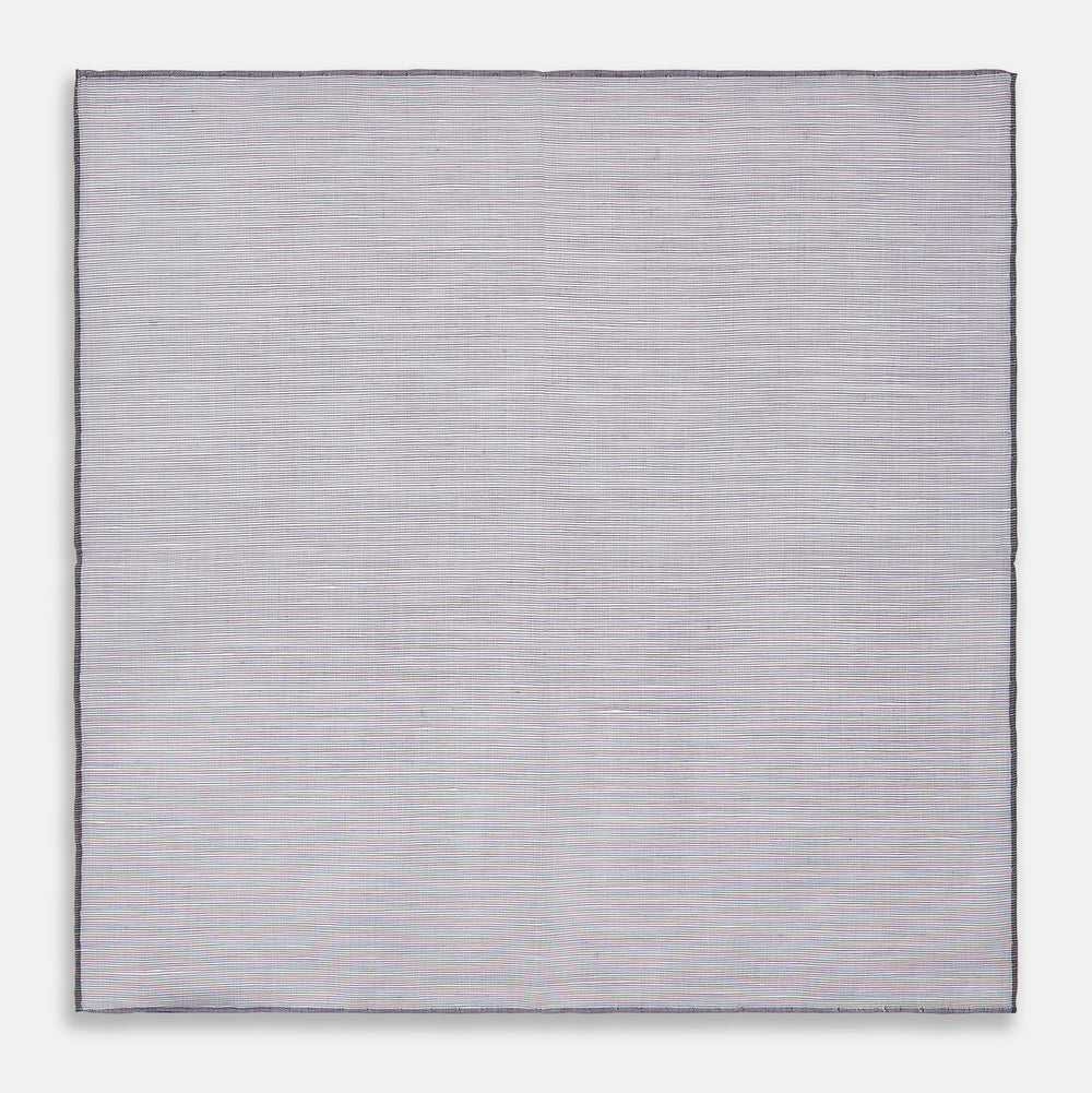 The Lilac Cotton-Blend Handkerchief by Turnbull & Asser is neatly folded with a corner flipped over, exposing the hand-rolled edges, and displayed against a white background.