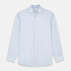 View 1 of product The Turnbull & Asser Tailored Fit Light Blue Cotton Shirt features a Kent collar and 3-button cuffs, perfect for pairing with a navy suit or smart ensemble. Laid flat on a white background.