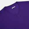 View 2 of product The Turnbull & Asser Purple Merino V-Neck Jumper features long sleeves and a rich, solid hue, making it an essential knitwear piece for any wardrobe.