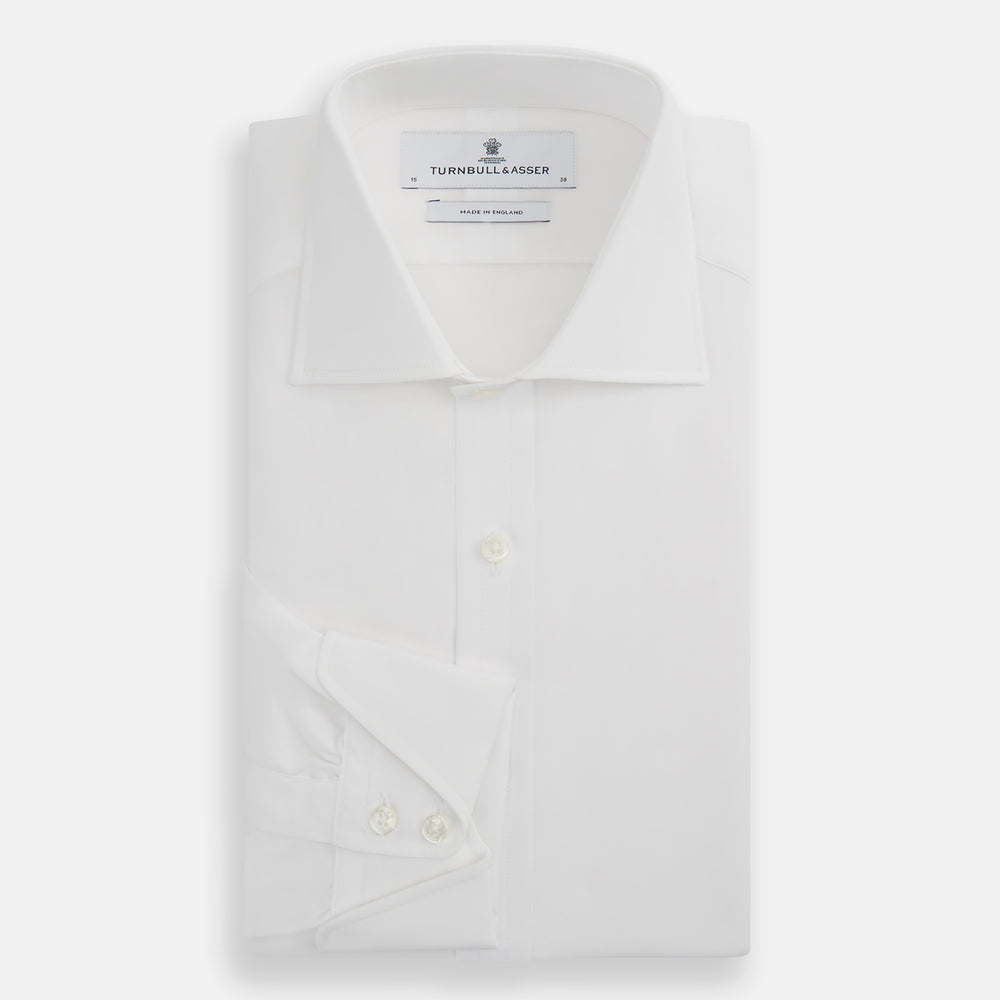 The Turnbull & Asser White Poplin Shirt With Regent Collar and 2-Button Cocktail Cuffs, featuring long sleeves, is buttoned up and laid flat on a white background.