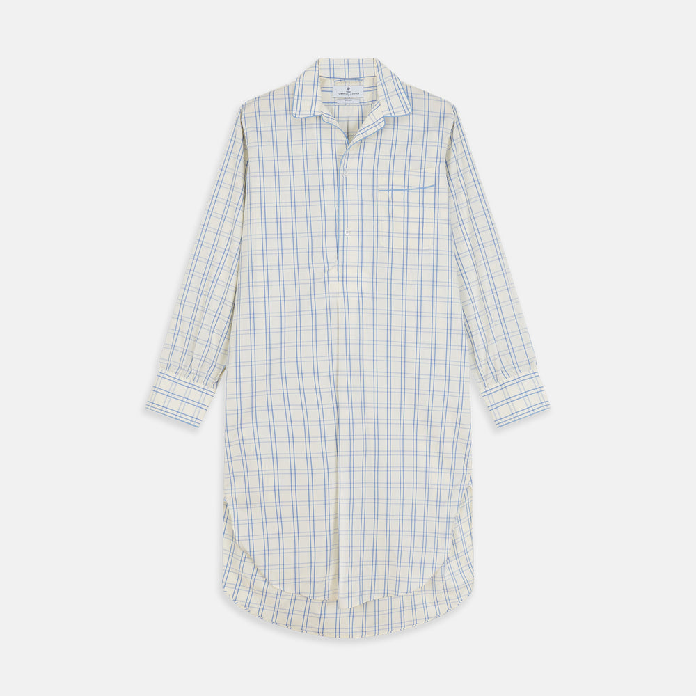 The Turnbull & Asser Cream Multi Cotton Sussex Nightshirt is a knee-length, long-sleeve shirt dress with a blue and beige plaid pattern, collar, front button placket, chest pocket, and rounded hem with side slits.