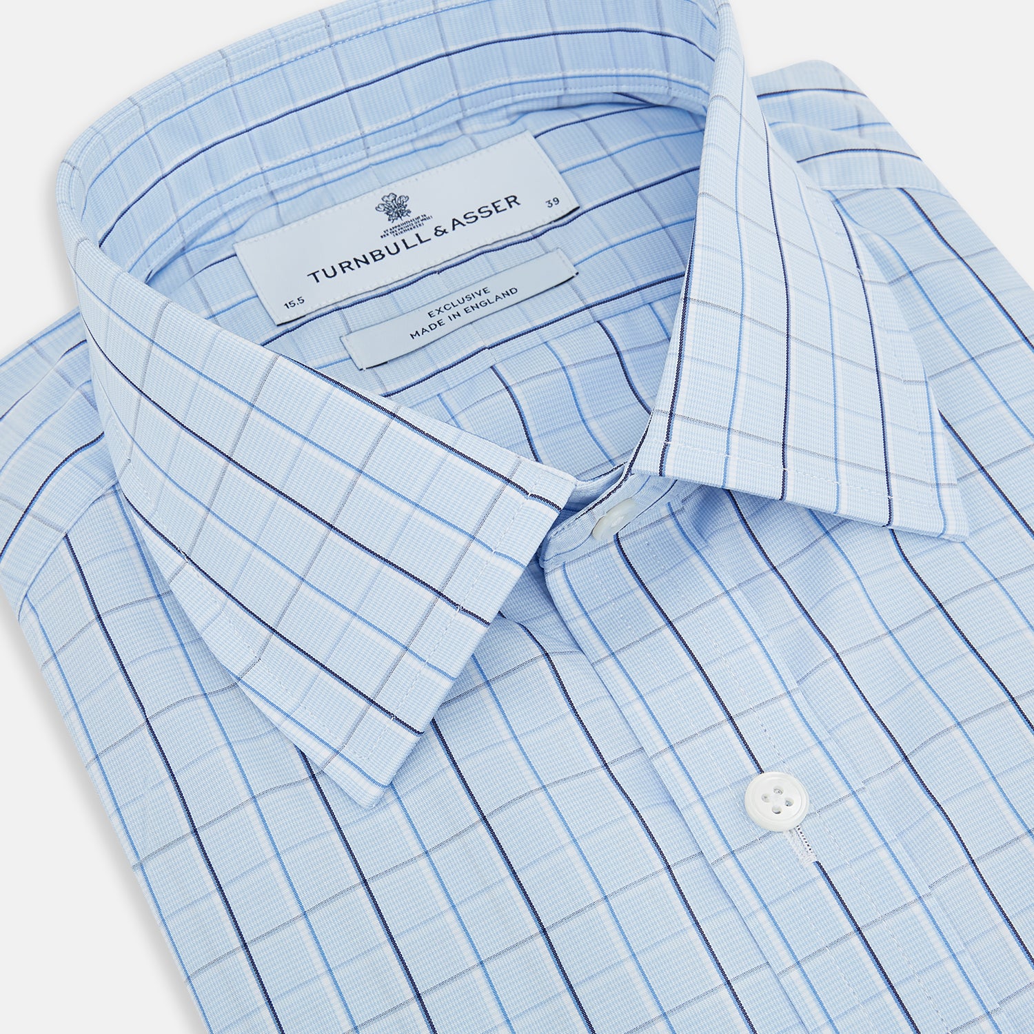 View 2 of product The Navy and Blue Combination Check Mayfair Shirt by Turnbull & Asser features a light blue base with a grid of thin dark blue lines, long sleeves, a pointed collar, and is neatly displayed on a plain white background.