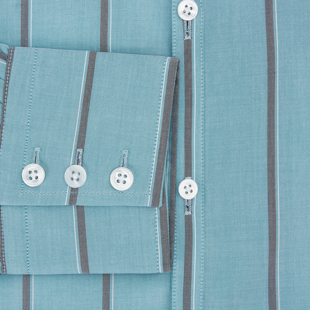 The Cendre Blue Track Stripe Westminster Shirt by Turnbull & Asser features a light blue hue, dark vertical stripes, button-down front, classic collar, and buttoned cuffs—showcasing British craftsmanship.