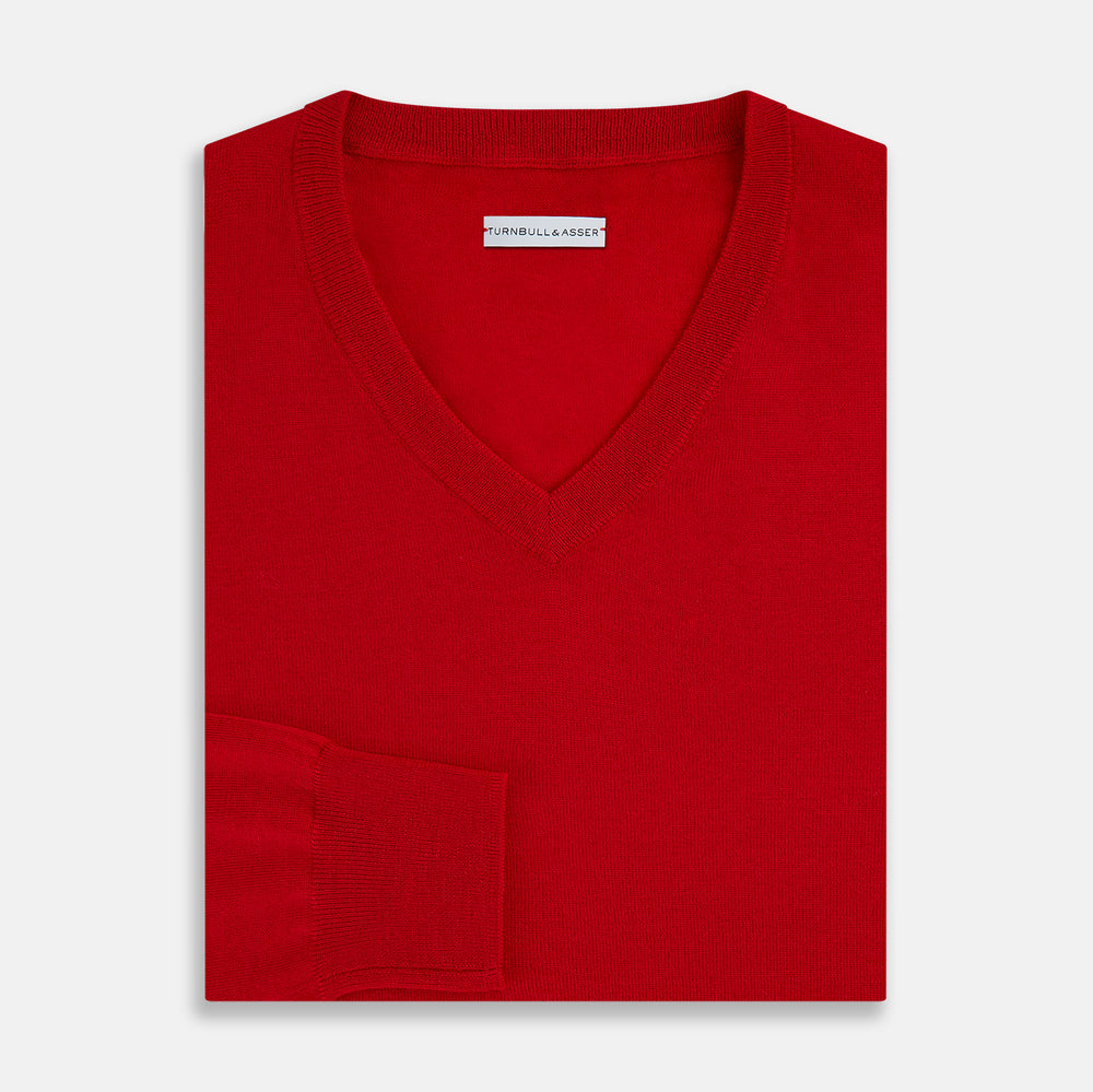 The Turnbull & Asser Red Fine Merino V-Neck Jumper, a classic long-sleeve knitwear piece, is shown on a white background.