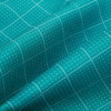 View 4 of product The Turquoise Dotted Check Pattern Printed Silk Cravat by Turnbull & Asser features a neatly folded diamond shape and a refined white dotted grid, showcasing classic style.