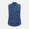 View 1 of product The Azzurro Double-Breasted Quilted Gilet by Turnbull & Asser is a sleeveless blue piece with black buttons, two zippered pockets, and a chest pocket—ideal for layered looks against a plain white background.