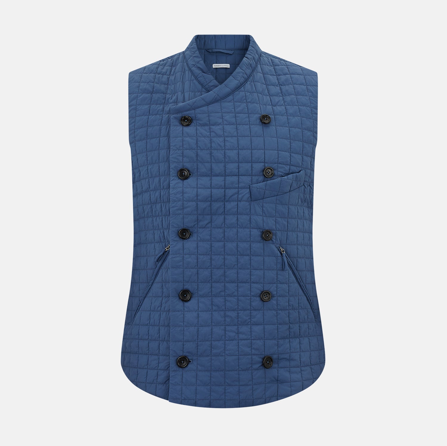 View 1 of product The Azzurro Double-Breasted Quilted Gilet by Turnbull & Asser is a sleeveless blue piece with black buttons, two zippered pockets, and a chest pocket—ideal for layered looks against a plain white background.