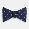 View 1 of product The Blue and Yellow Links Silk Bow Tie by Turnbull & Asser features a subtle wavy texture with a refined pattern of interlinked gold, blue, and white rings—an elegant accessory to enhance any formal outfit.