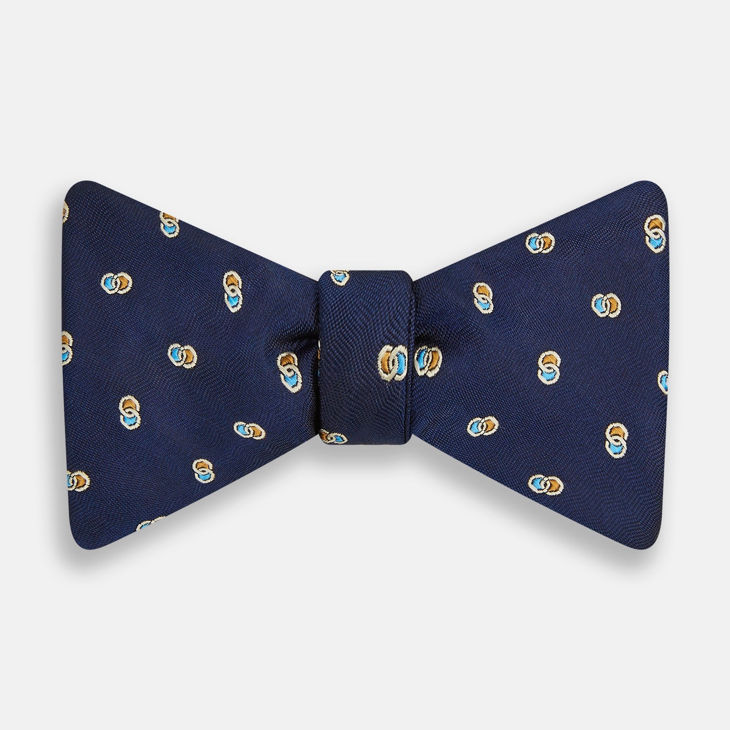 View 1 of product The Blue and Yellow Links Silk Bow Tie by Turnbull & Asser features a subtle wavy texture with a refined pattern of interlinked gold, blue, and white rings—an elegant accessory to enhance any formal outfit.