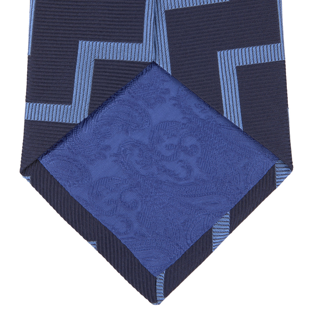 The Turnbull & Asser Navy and Light Blue Striped Zigzag Silk Tie features a striking zigzag pattern—a stylish accessory for the modern gentleman.