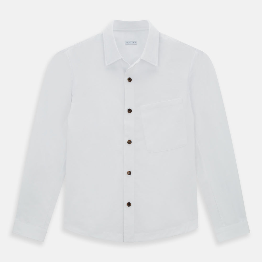 The White Hyde Overshirt by Turnbull & Asser is crafted from sanforised cotton with a left chest pocket and dark buttons—offering a sharp, casual blazer alternative. Shown laid flat on a white background.