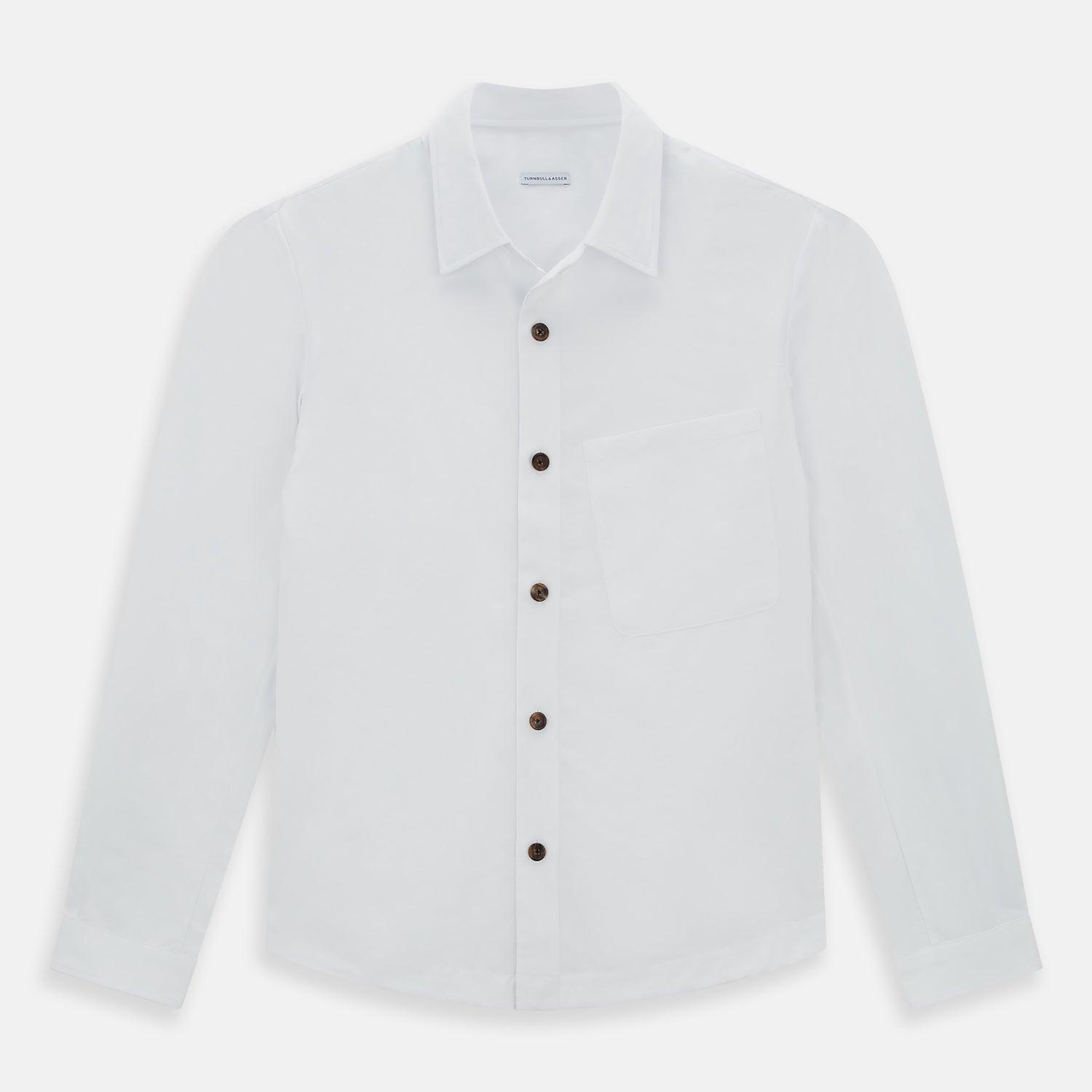 View 1 of product The White Hyde Overshirt by Turnbull & Asser is crafted from sanforised cotton with a left chest pocket and dark buttons—offering a sharp, casual blazer alternative. Shown laid flat on a white background.