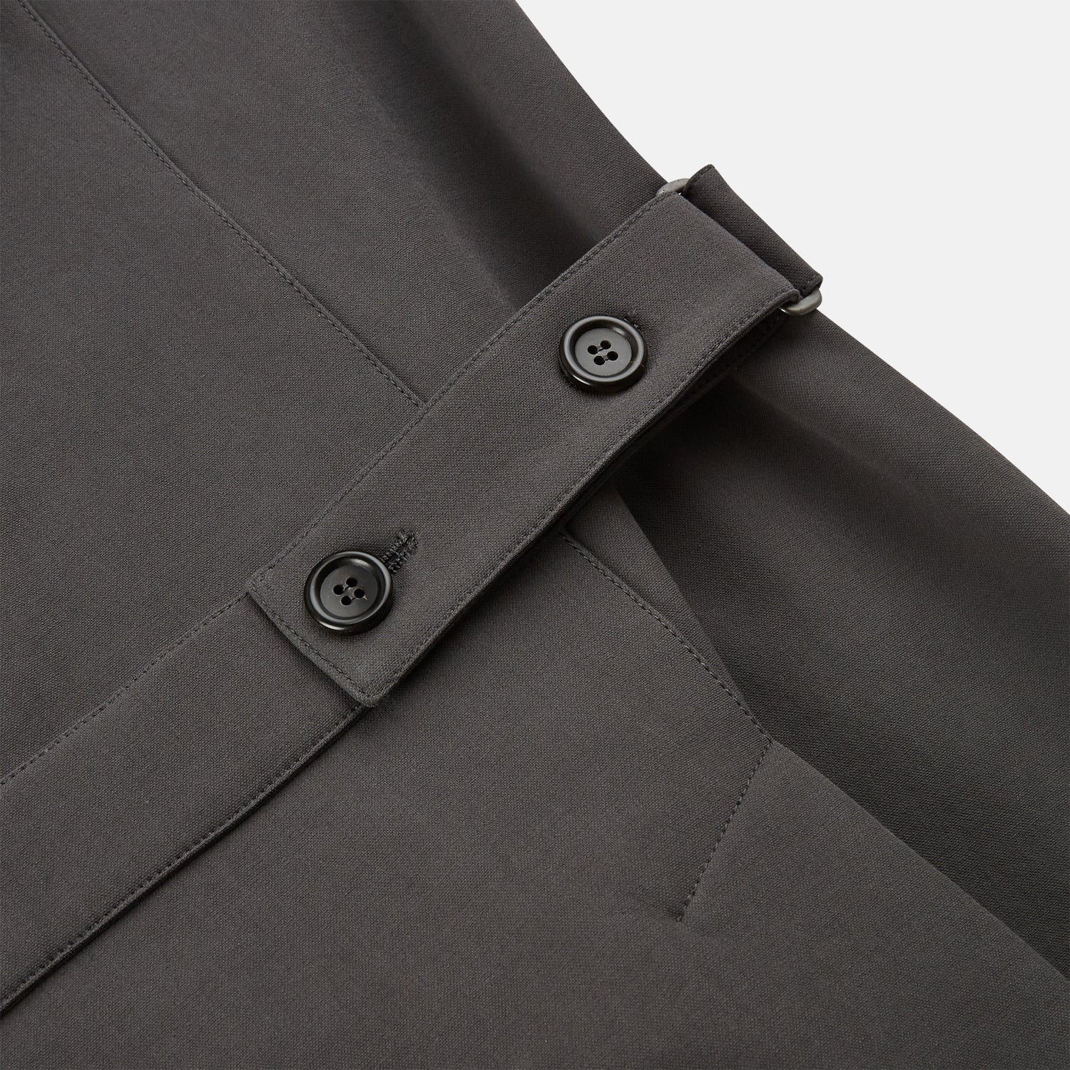 View 5 of product The Turnbull & Asser Charcoal Melange John Arthur Trench Coat, featuring a collar, single-breasted closure, and three zippered pockets—one chest and two at the hips—is shown against a plain white background.