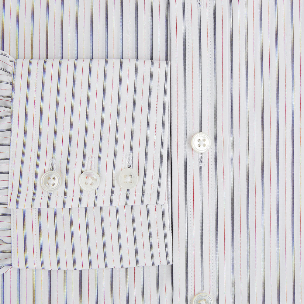 The Turnbull & Asser Midnight Blue and Red Ticking Stripe Mayfair Shirt features long sleeves, a pointed collar, buttoned cuffs, and fine Italian cotton—an essential men's wardrobe piece shown on a plain white background.