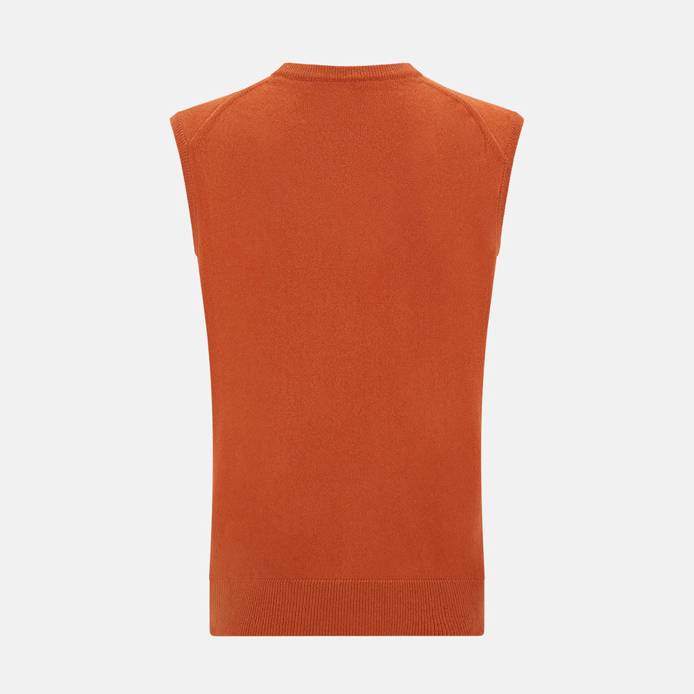 The Turnbull & Asser Orange Cashmere V-Neck Vest adds vibrant style to men’s fashion, featuring a ribbed hem and sleeveless design. Shown against a plain white background.