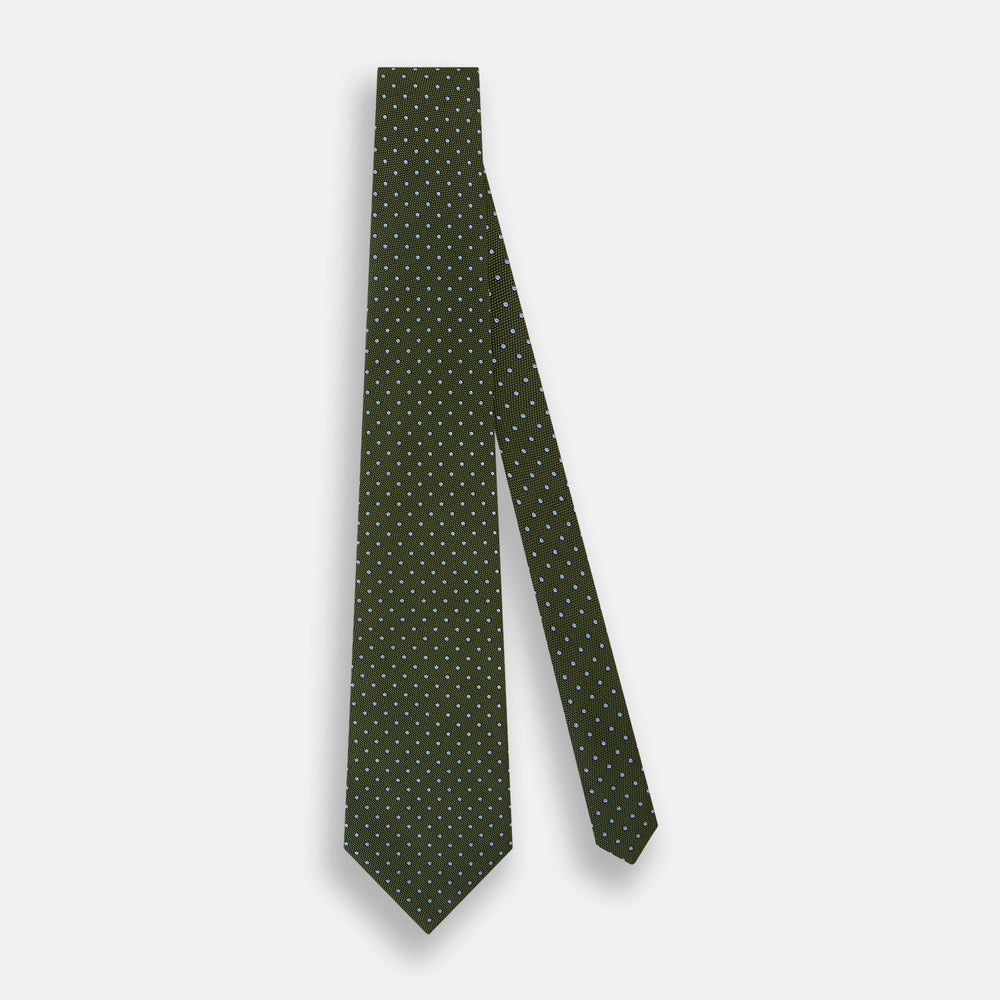 The Turnbull & Asser Green and Blue Micro Dot Silk Tie is shown rolled up, displaying small light blue dots on green silk against a plain white background.