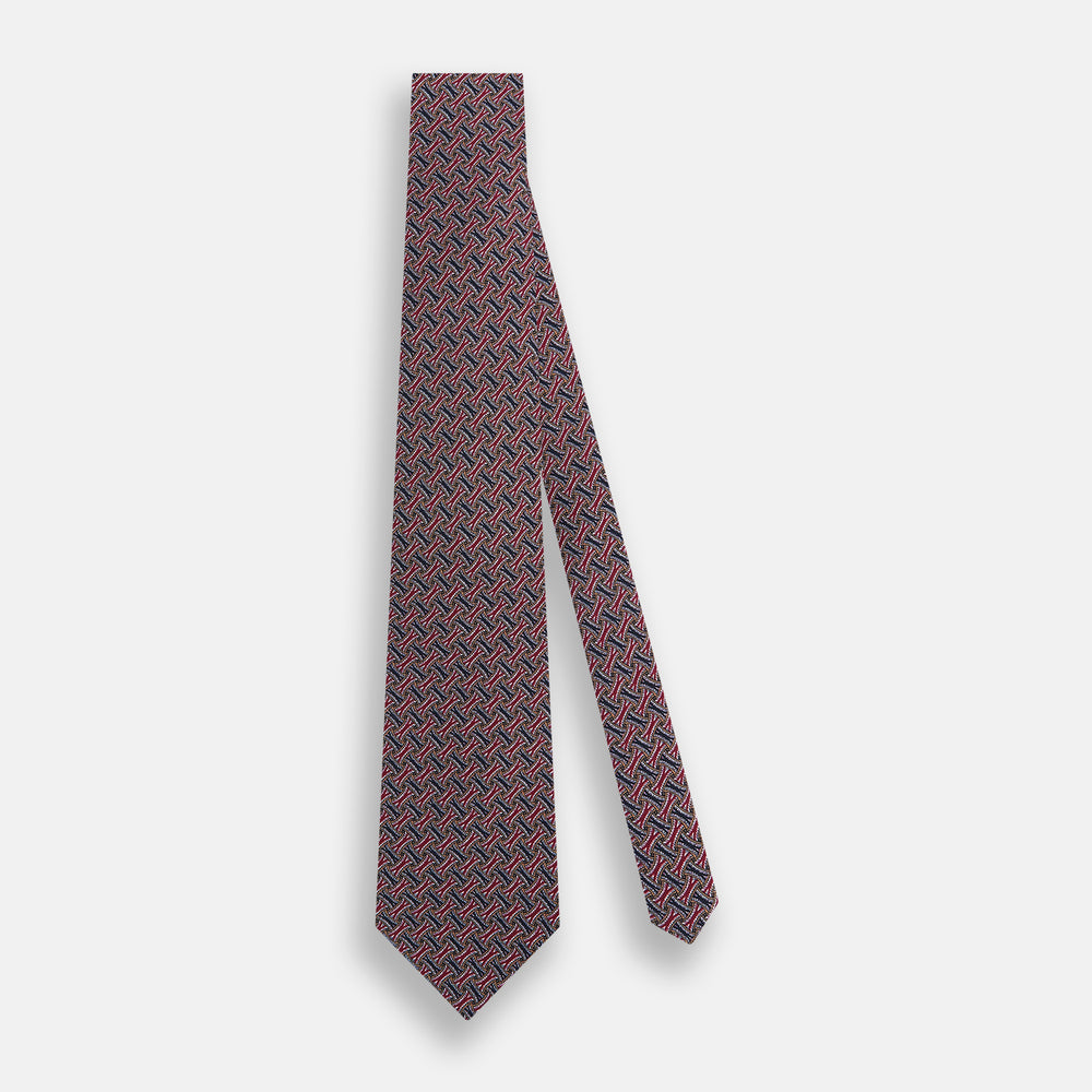 The Turnbull & Asser Burgundy and Navy Weave Patterned Silk Tie features a geometric design in rich tones on silk fabric.