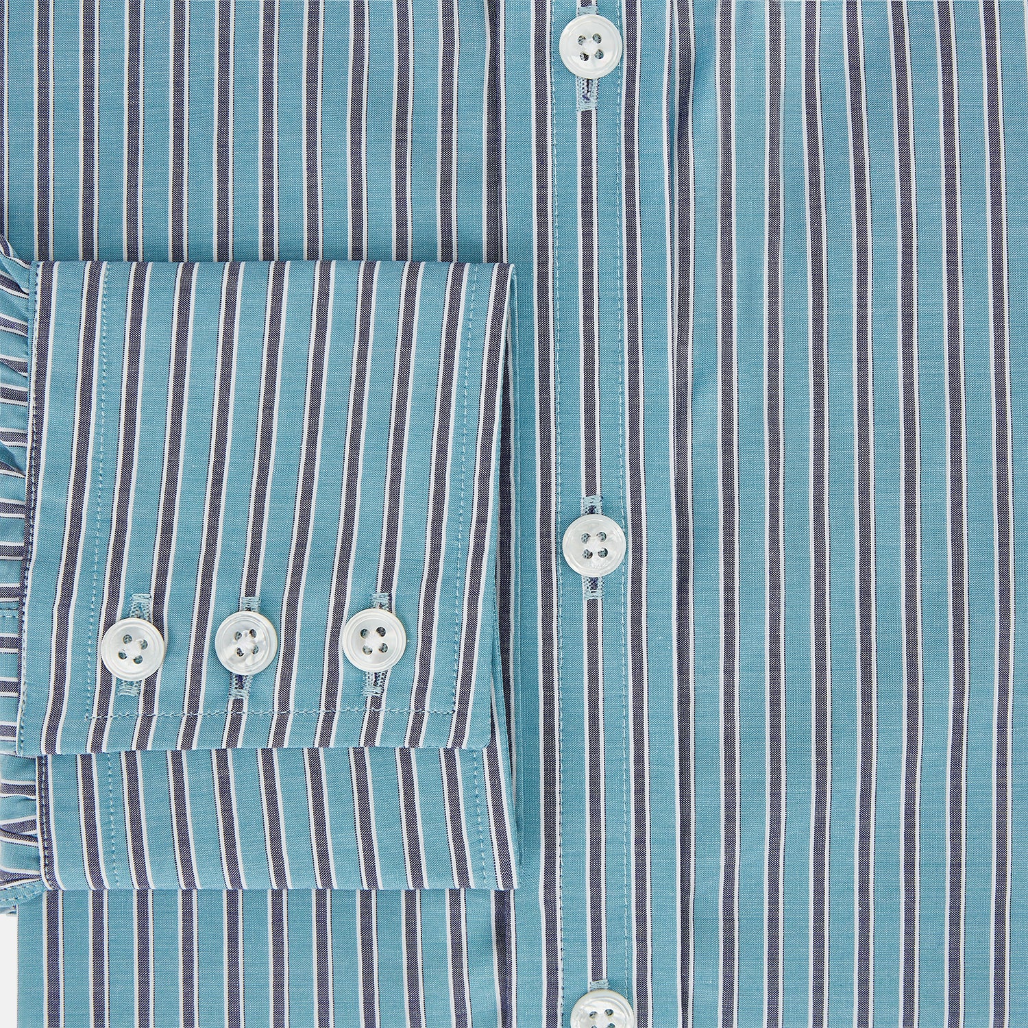 View 4 of product The Turnbull & Asser Turquoise Ticking Stripe Mayfair Shirt is a long-sleeve, button-up shirt in fine Italian cotton with light blue and white stripes, a collar, white buttons, curved hem, and subtle turquoise ticking stripe.
