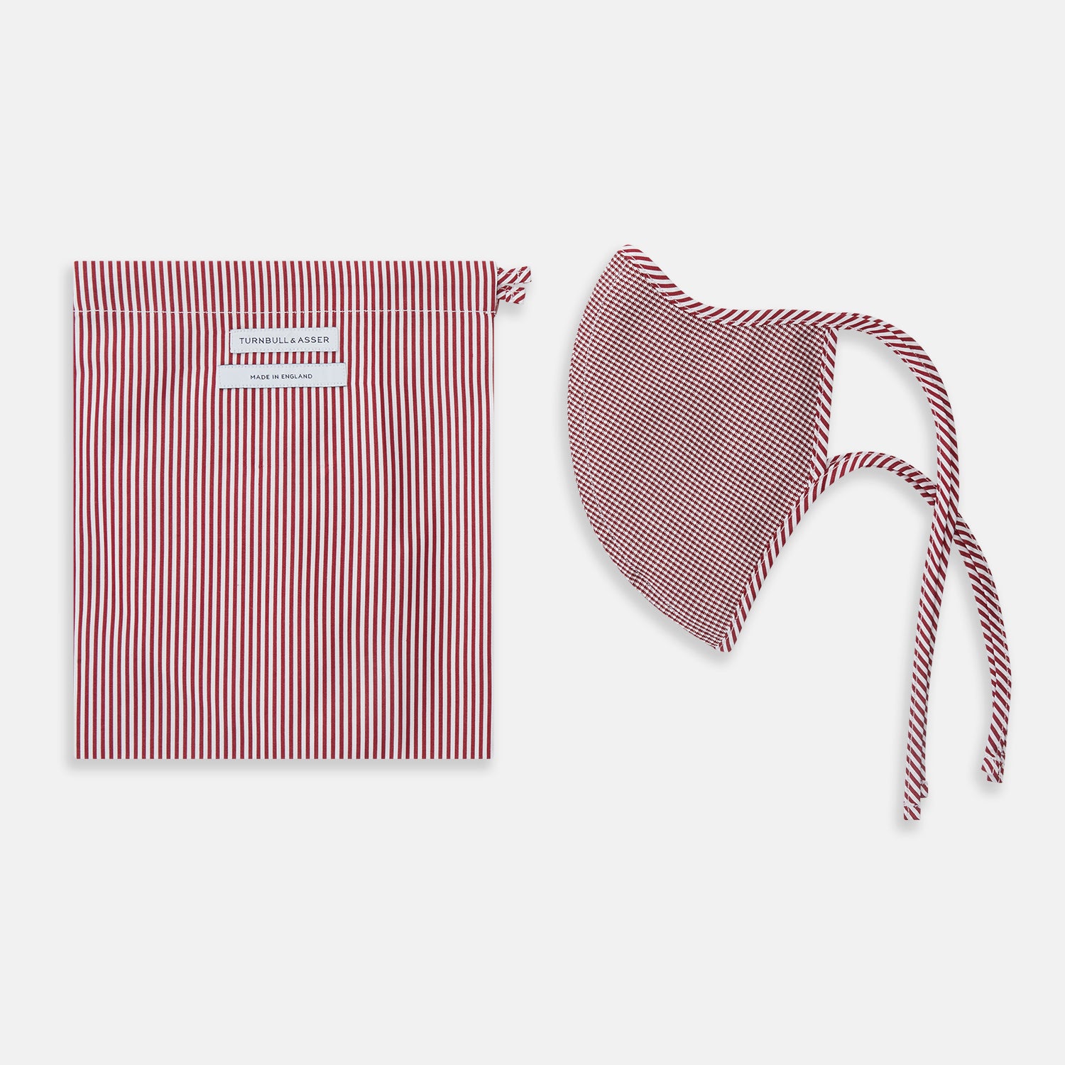 View 2 of product The Turnbull & Asser Burgundy Check Commuter Mask comes with 3 Viroformula™ filters. It features a check pattern, adjustable ear straps, and is displayed on a plain white background.