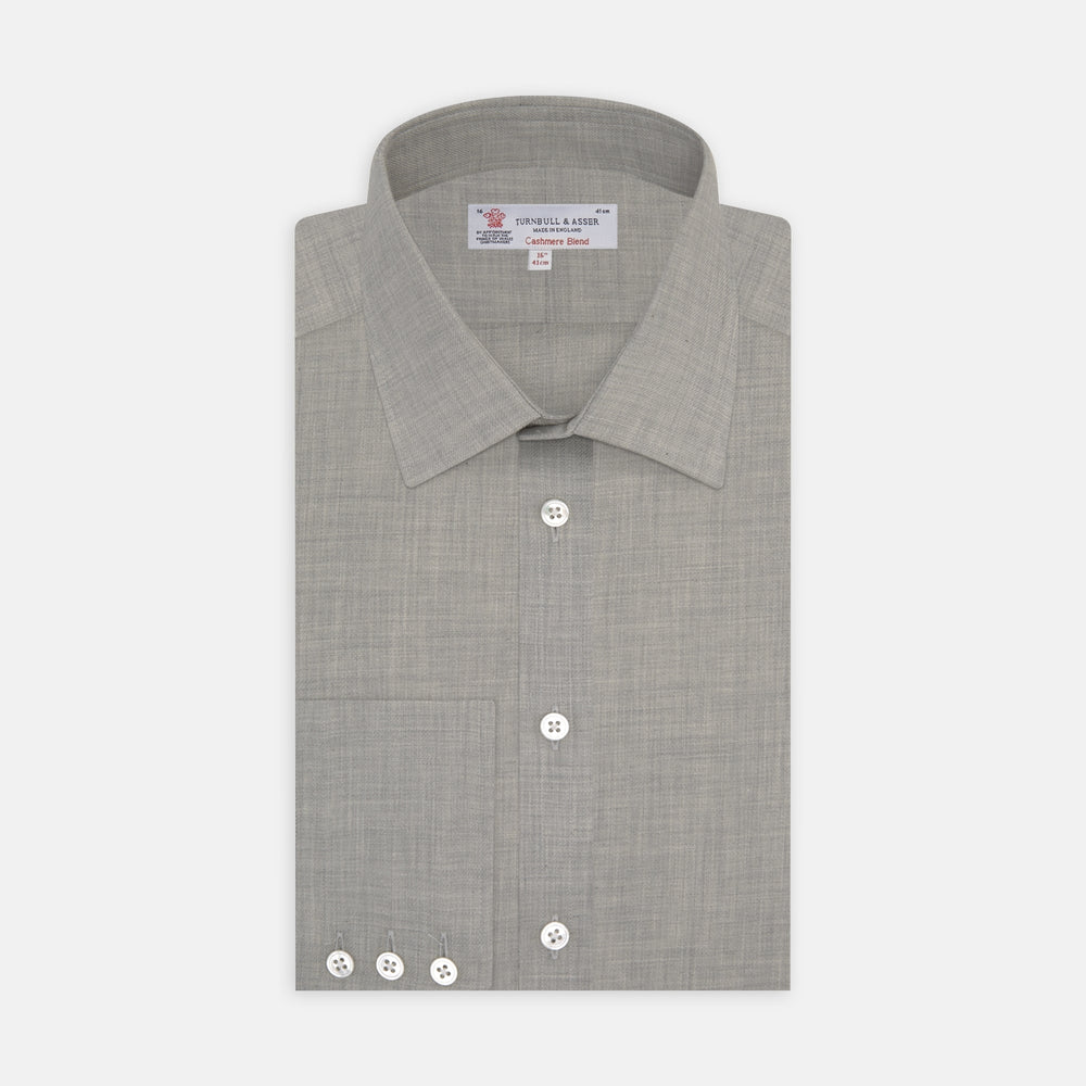 The Turnbull & Asser Grey Cashmere Blend Shirt features a T&A collar, 3-button cuffs, and a front pocket, shown neatly folded with white buttons against a plain white background.