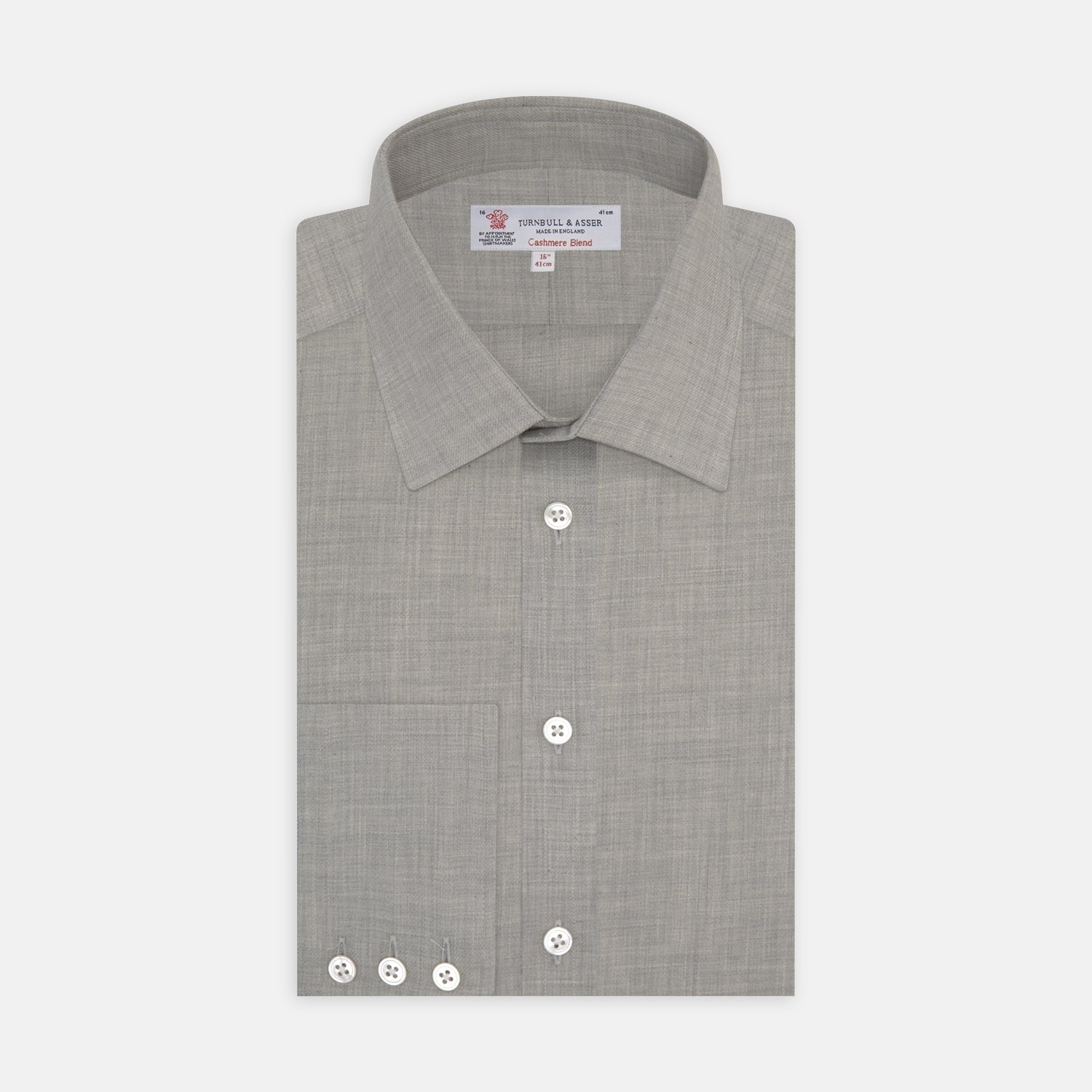 View 1 of product The Turnbull & Asser Grey Cashmere Blend Shirt features a T&A collar, 3-button cuffs, and a front pocket, shown neatly folded with white buttons against a plain white background.