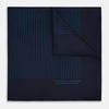 View 1 of product The Navy and Blue Stripe Silk Pocket Square by Turnbull & Asser features vertical blue pinstripes, is crafted from silk with hand-rolled edges, and is finished with the brand's logo printed in blue at the lower right corner.