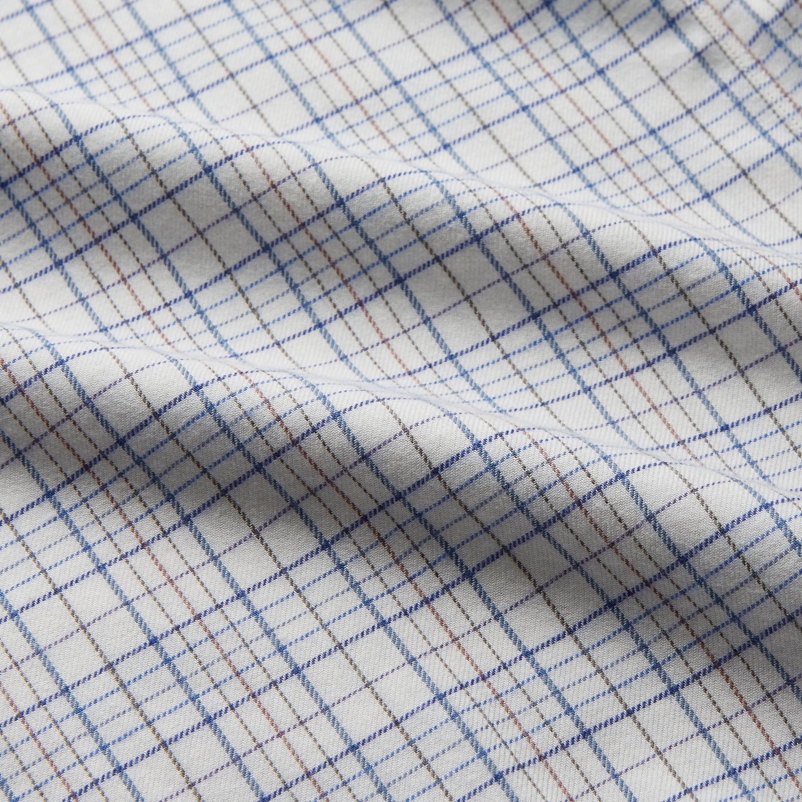 View 4 of product The Turnbull & Asser Blue Multi Check Regular Fit Cotton-Cashmere Shirt features a T&A collar, 3 button cuffs, and a white background with tonal blue and light brown checks—shown flat against a white background.