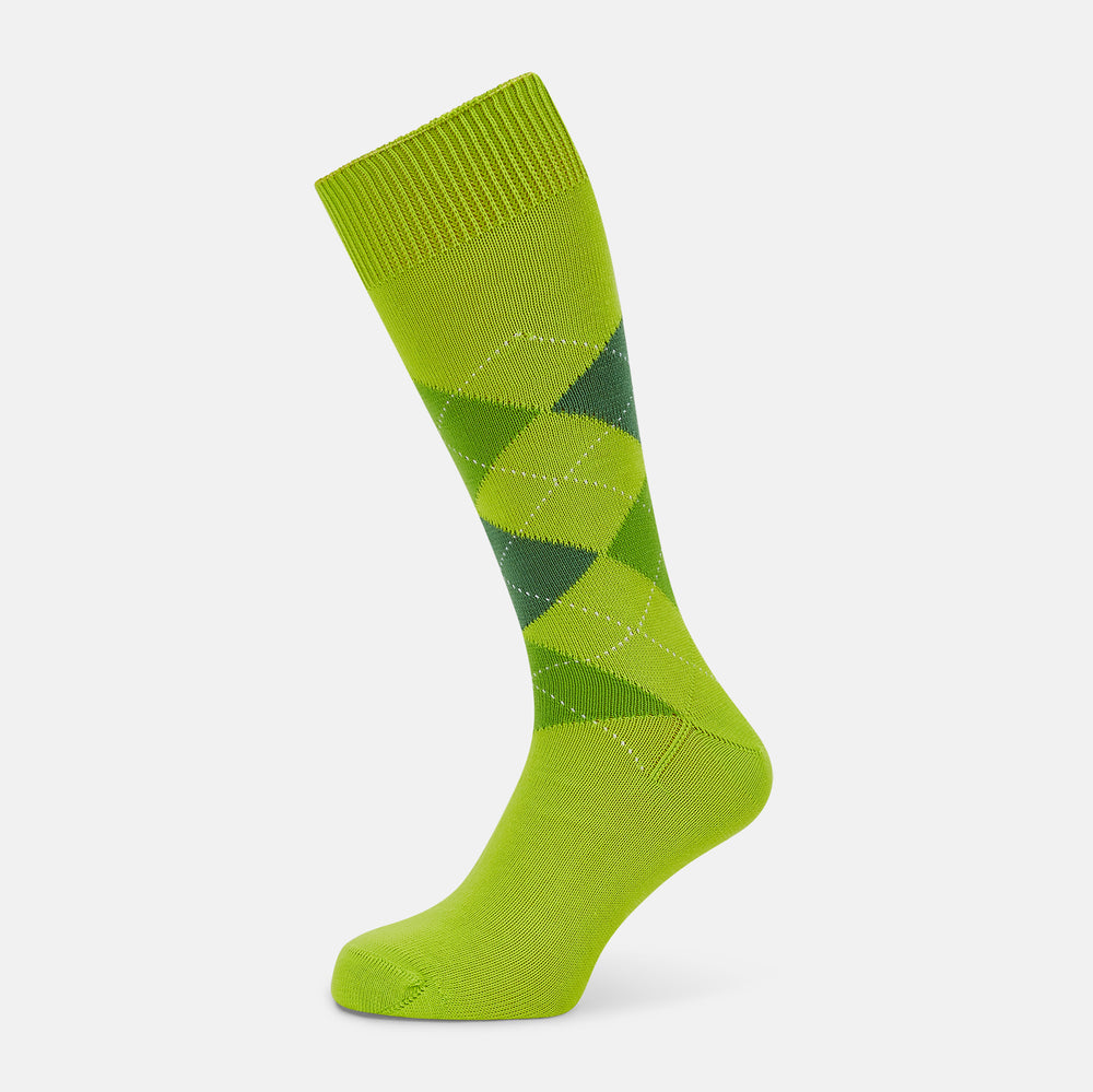 The Lime Check Mid-Length Sock by Turnbull & Asser features a green and yellow argyle pattern with a ribbed cuff, crafted from comfortable cotton material, and is shown on a plain light background.