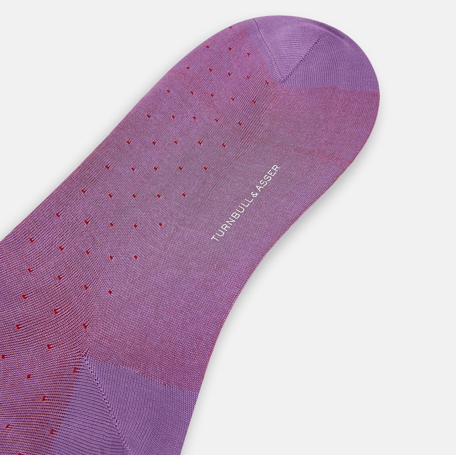 View 3 of product A single Pink/Red Polka Dot Long Sock by Turnbull & Asser, featuring a ribbed cuff and subtle red polka dots, is displayed against a plain white background.