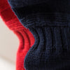 View 4 of product The Red Lewis Guernsey Knitted Jumper by Turnbull & Asser is a bright red wool-cotton, long-sleeve jumper with a round neckline, ribbed cuffs, and ribbed hem, shown against a white background.
