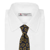 View 3 of product The Navy and Gold Petal Paisley Silk Tie by Turnbull & Asser features a repeating yellow abstract pattern, neatly rolled on a white background.