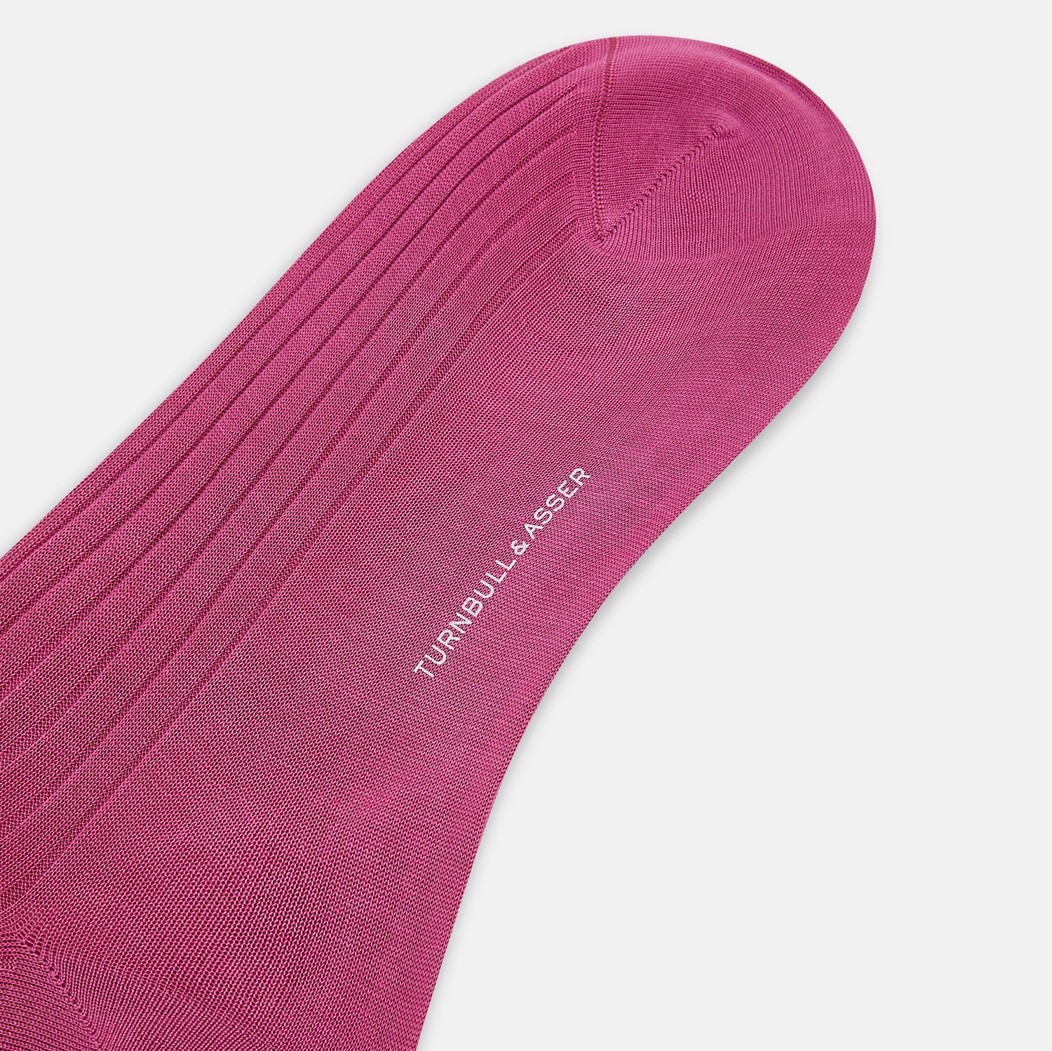 View 3 of product A single Turnbull & Asser Pink Mid-Length Sock is shown upright on a plain white background. The luxury sock has a ribbed texture and a subtly darker ribbed cuff at the top, creating an elegant finish.