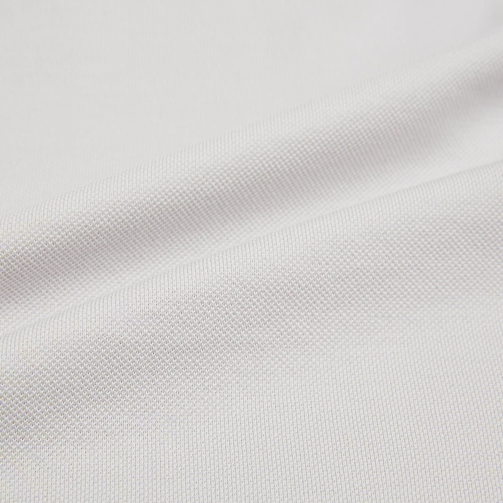 A pale pink luxury cotton rugby polo shirt by Turnbull & Asser, featuring long sleeves and a collar with no buttons, displayed flat on a white background.